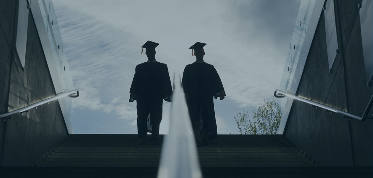 Two graduates walking together
