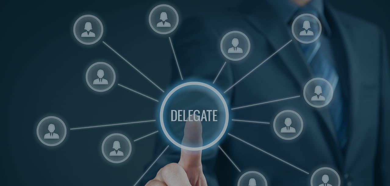 Business person pointing to a graphic of a circle with delegate written in the centre